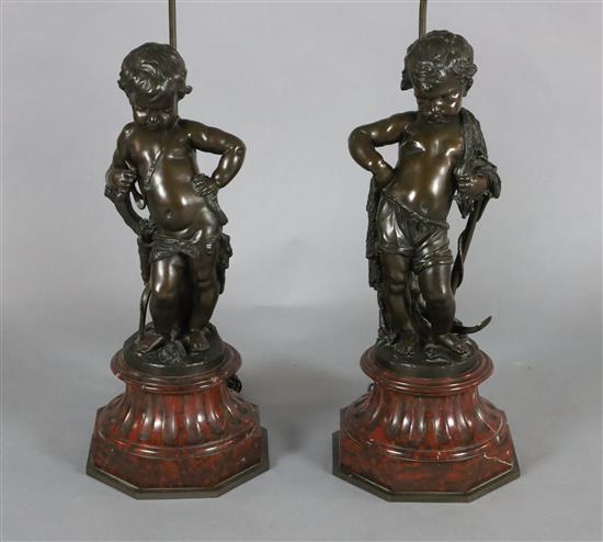 A pair of Victorian bronze figures of putti, H. 23.5in.